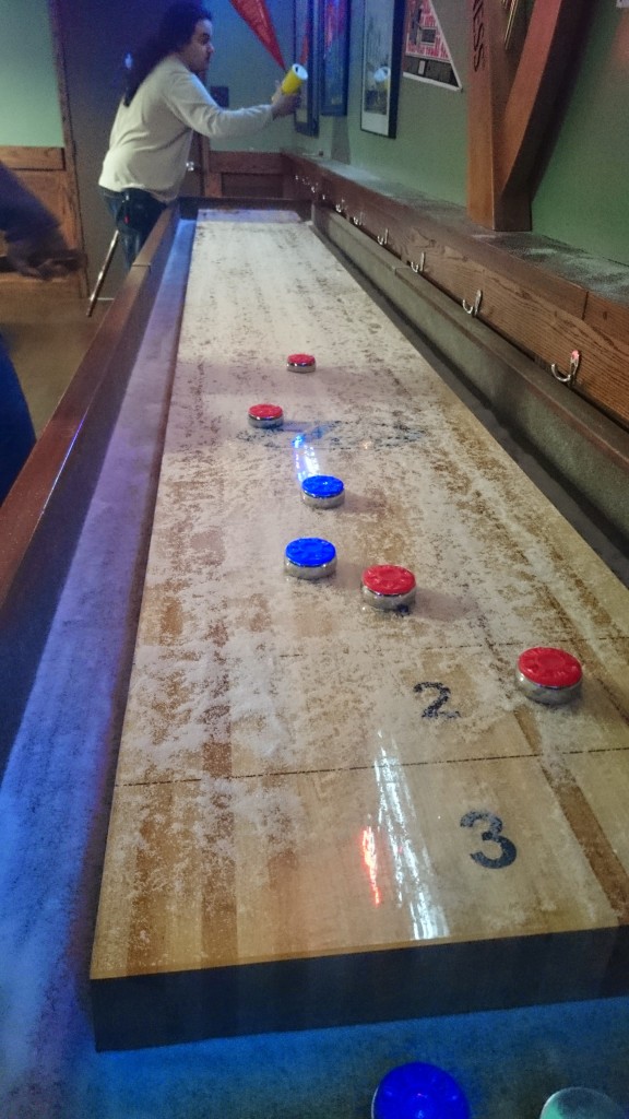 Curling on a table, i.e. shuffleboard